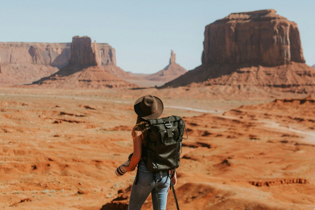 Woman with a backpack hiking in the desert
