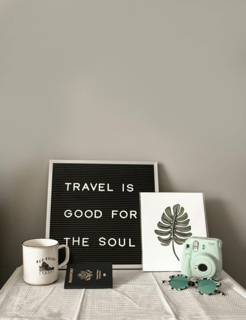 Sign saying "travel is good for the soul"